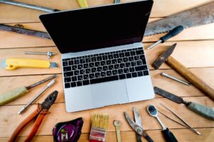 Laptop surrounded by carpentry tools
